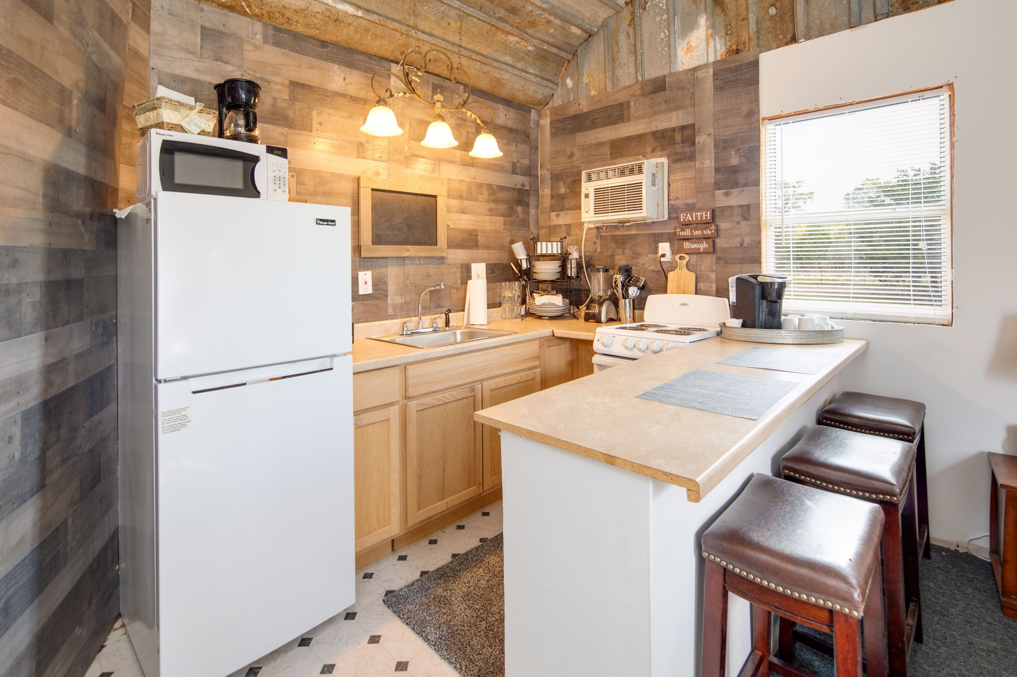 272 Pine Road Somerville, TX 77879 - Photo 3 of 22 a kitchen with a sink a refrigerator and a stove