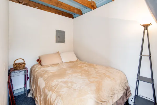a large bed sitting in a bedroom next to a window