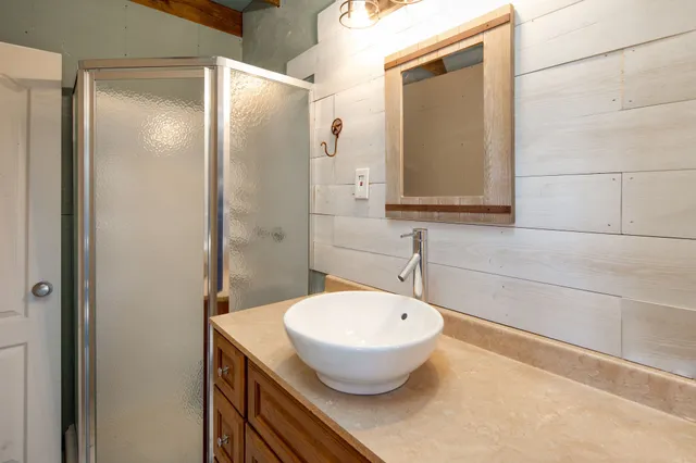 a bathroom with a sink and mirror