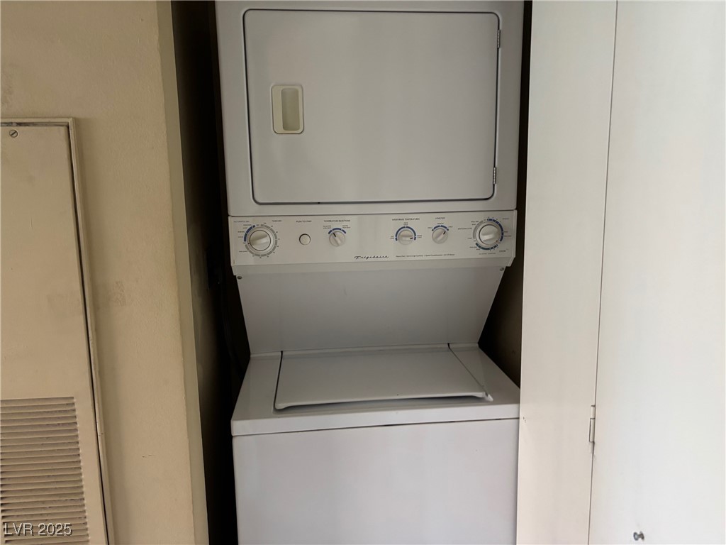 7300 West Pirates Cove Road, Unit 2054 Las Vegas, NV 89145 - Photo 12 of 16 Washroom with stacked washing machine and dryer