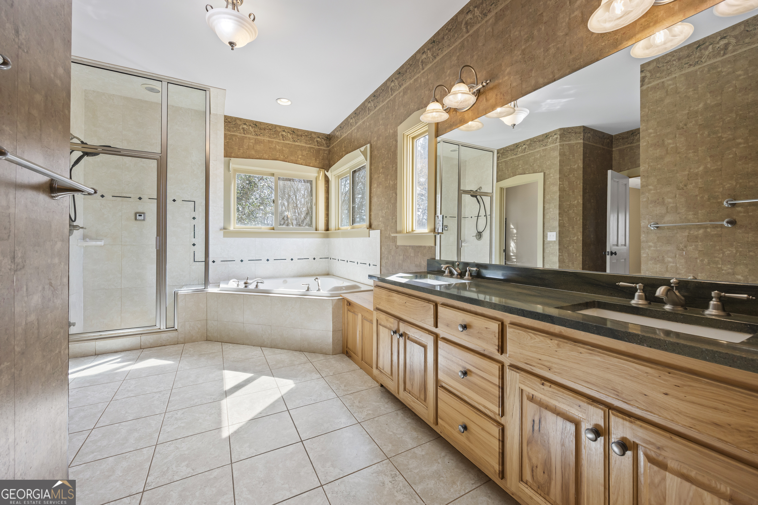 2223 Salem Road Watkinsville, GA 30677 - Photo 16 of 94 a spacious bathroom with a double vanity sink a mirror and a bathtub