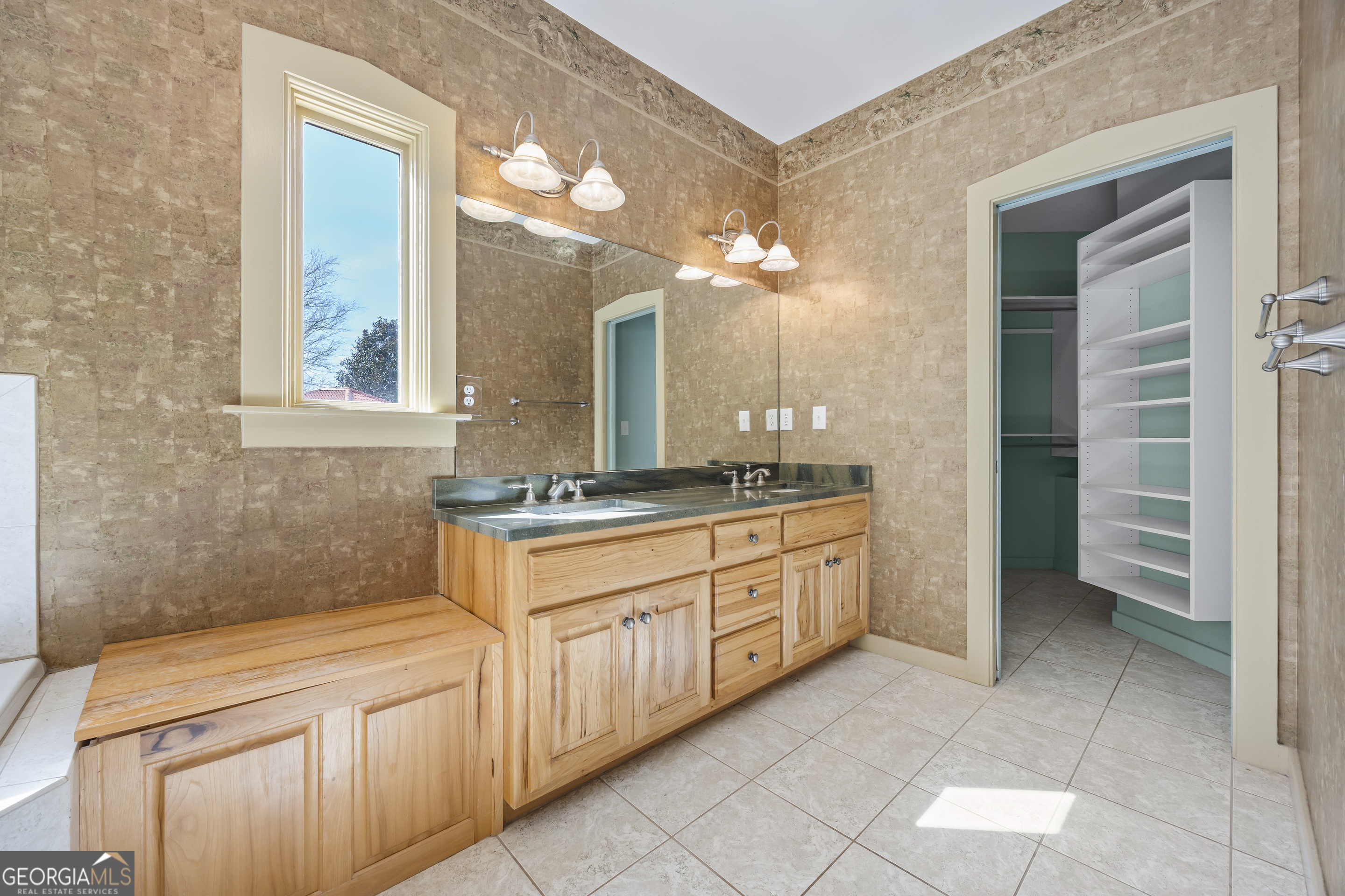 2223 Salem Road Watkinsville, GA 30677 - Photo 17 of 94 a spacious bathroom with a granite countertop sink a mirror and a
