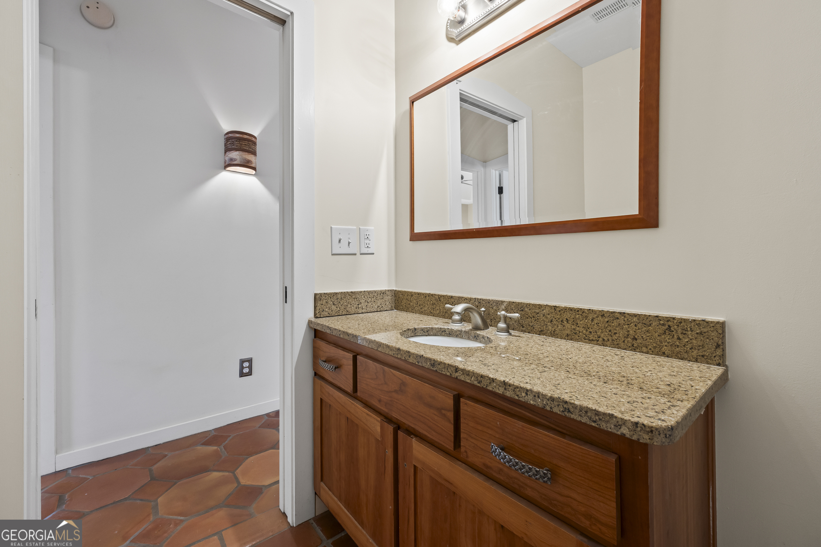 2223 Salem Road Watkinsville, GA 30677 - Photo 26 of 94 a bathroom with a granite countertop sink and a mirror