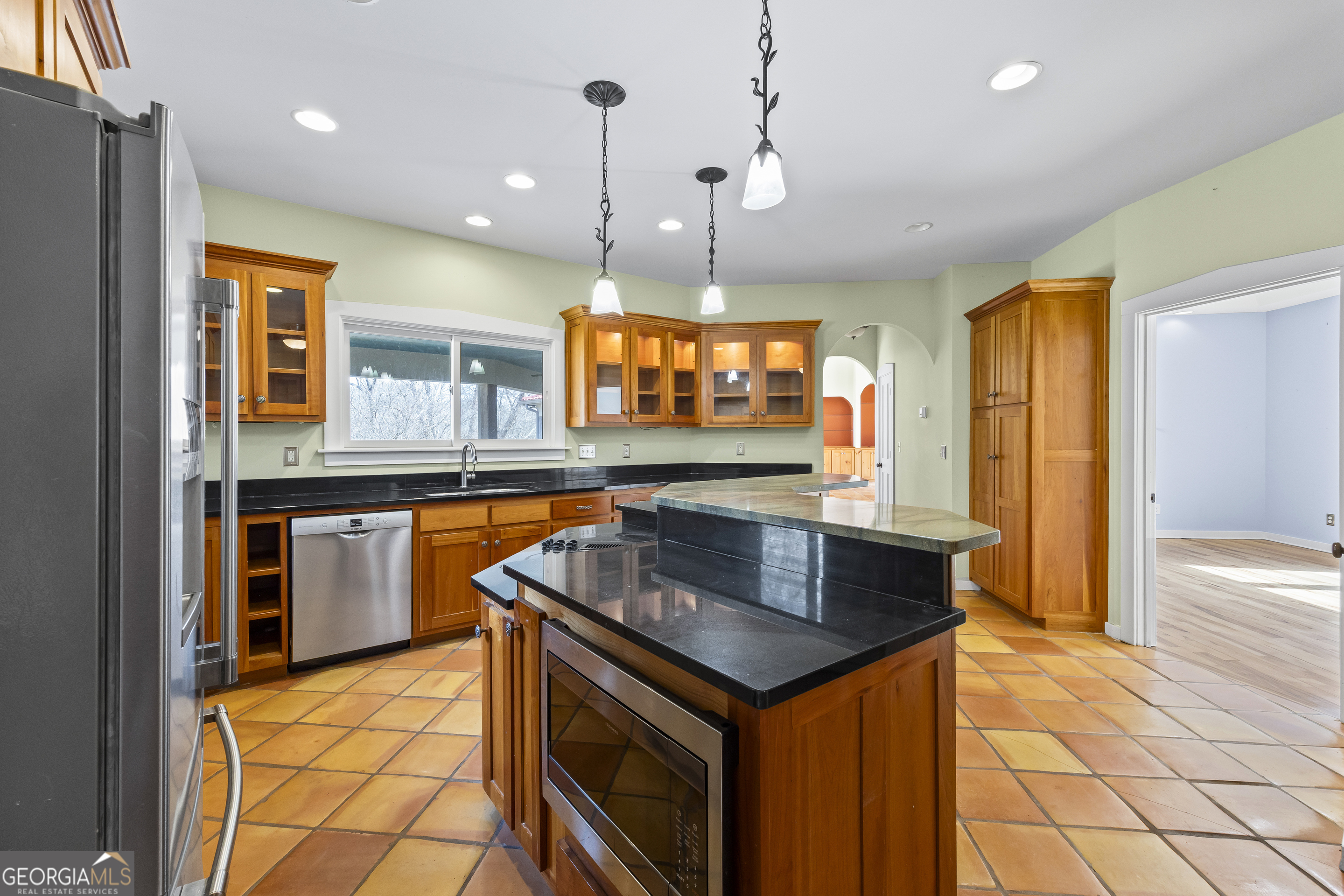 2223 Salem Road Watkinsville, GA 30677 - Photo 30 of 94 a kitchen with stainless steel appliances granite countertop a sink a stove and a wooden cabinets