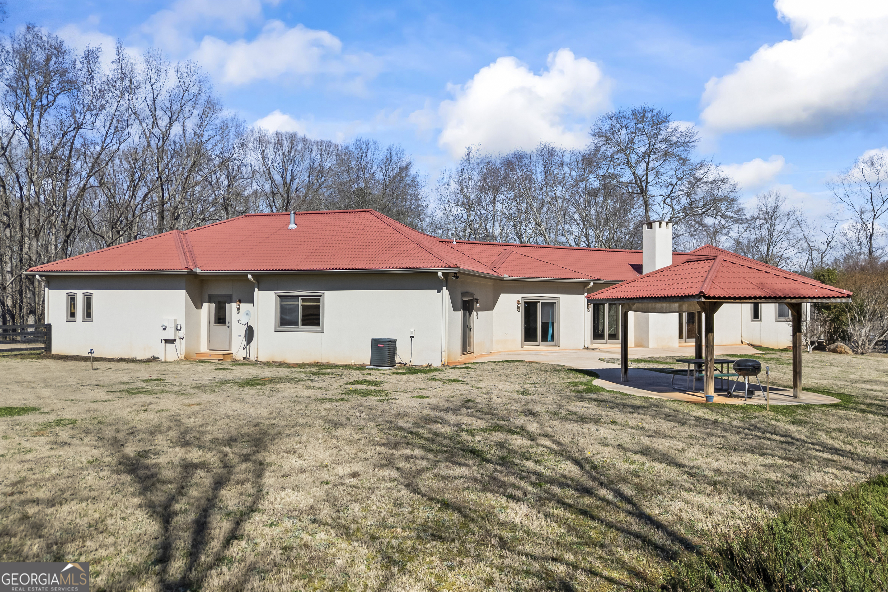 2223 Salem Road Watkinsville, GA 30677 - Photo 53 of 94 a house with table and chairs under an umbrella