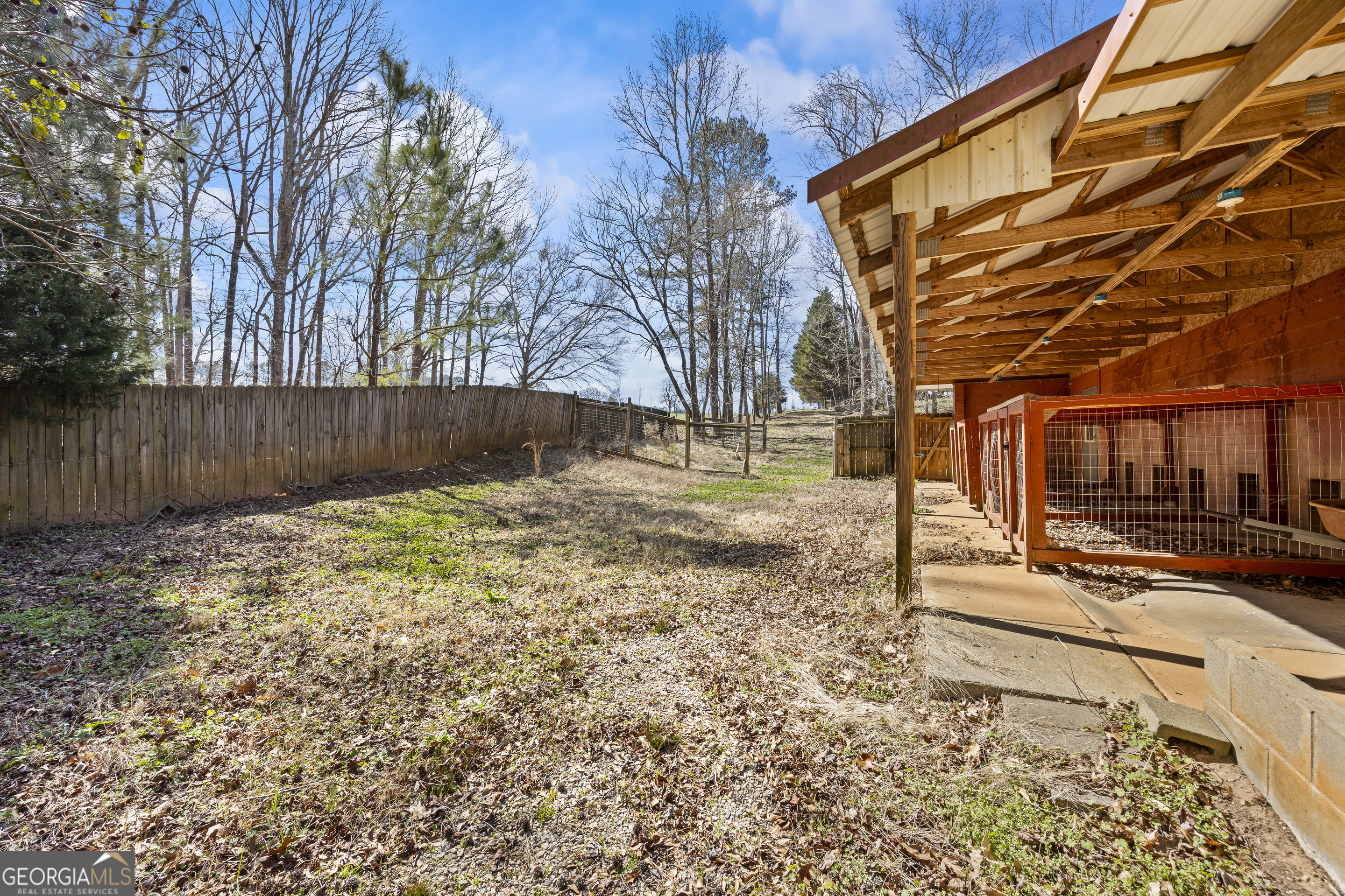 2223 Salem Road Watkinsville, GA 30677 - Photo 70 of 94 a backyard of a house with wooden fence and large trees