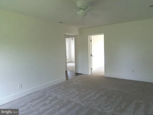 an empty room with a empty space and windows