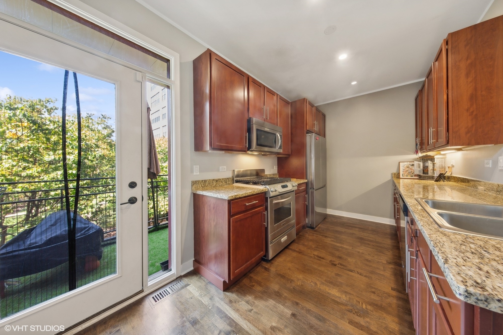 1244 West Monroe Street, Unit 6 Chicago, IL 60607 - Photo 3 of 21 a kitchen with stainless steel appliances granite countertop a stove a sink and a refrigerator