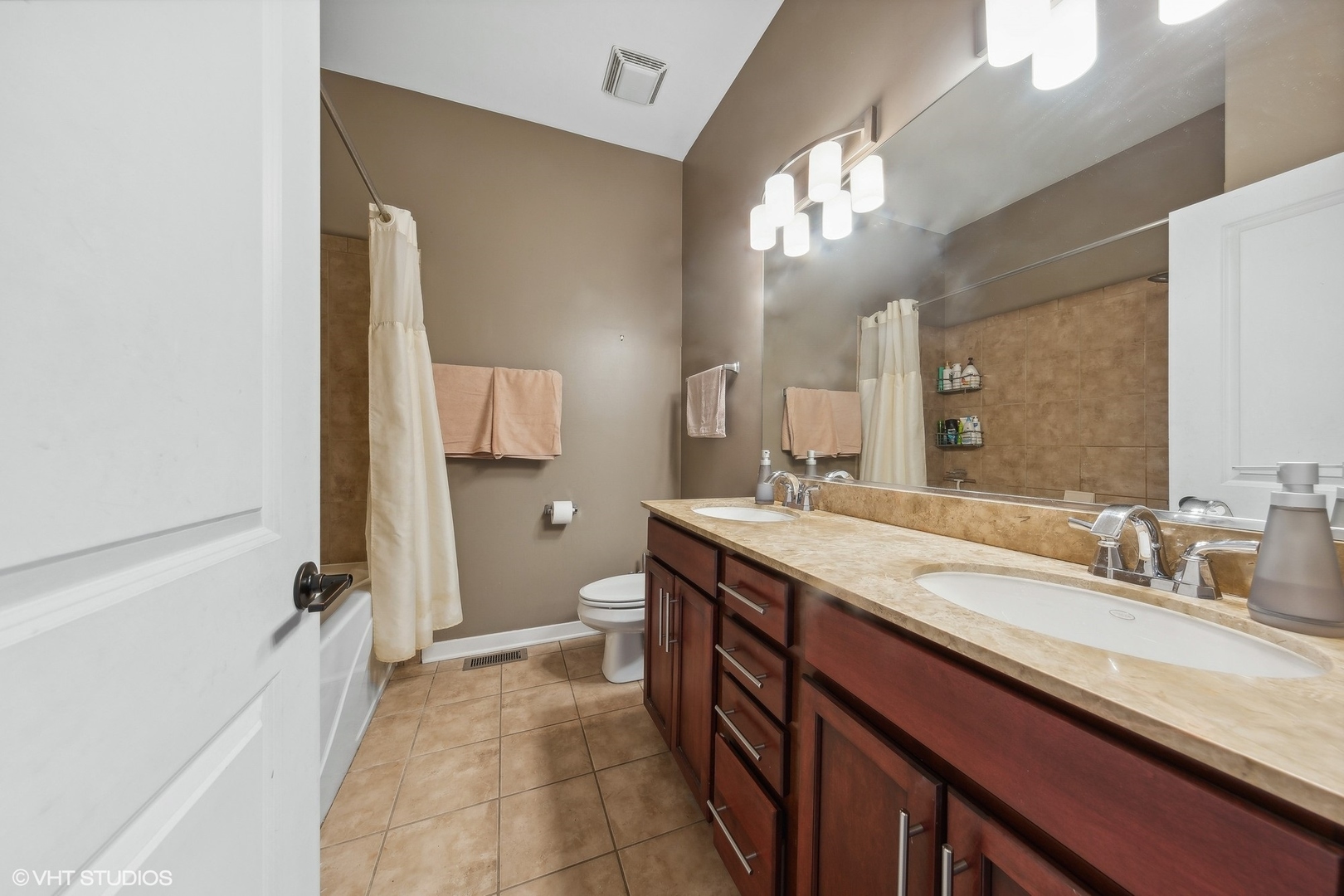 1244 West Monroe Street, Unit 6 Chicago, IL 60607 - Photo 10 of 21 a spacious bathroom with a granite countertop sink a toilet a mirror and shower