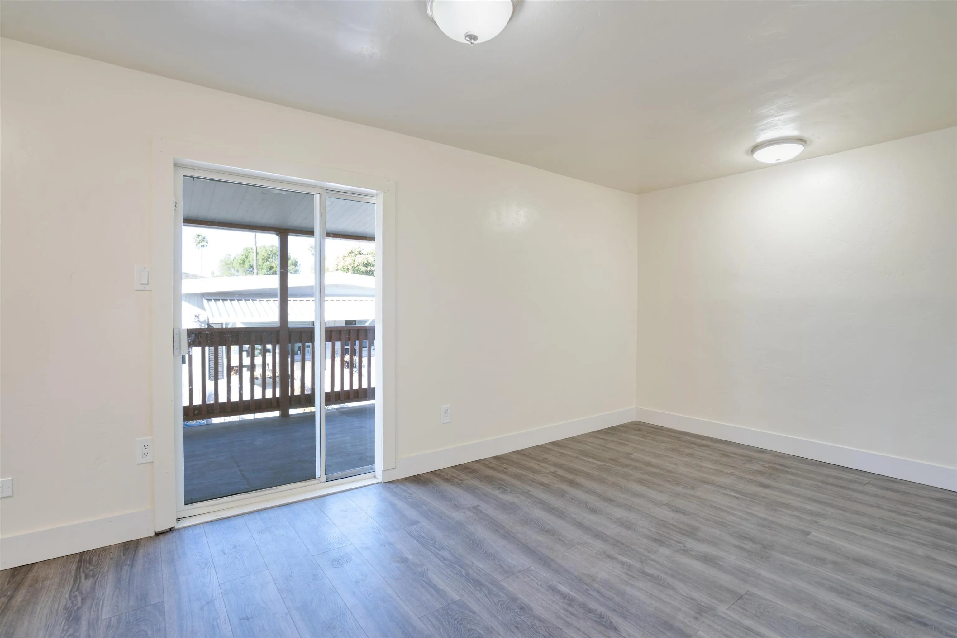 13490 Highway 8 Business, Unit SPC 14 Lakeside, CA 92040 - Photo 12 of 25 wooden floor in an empty room with a window