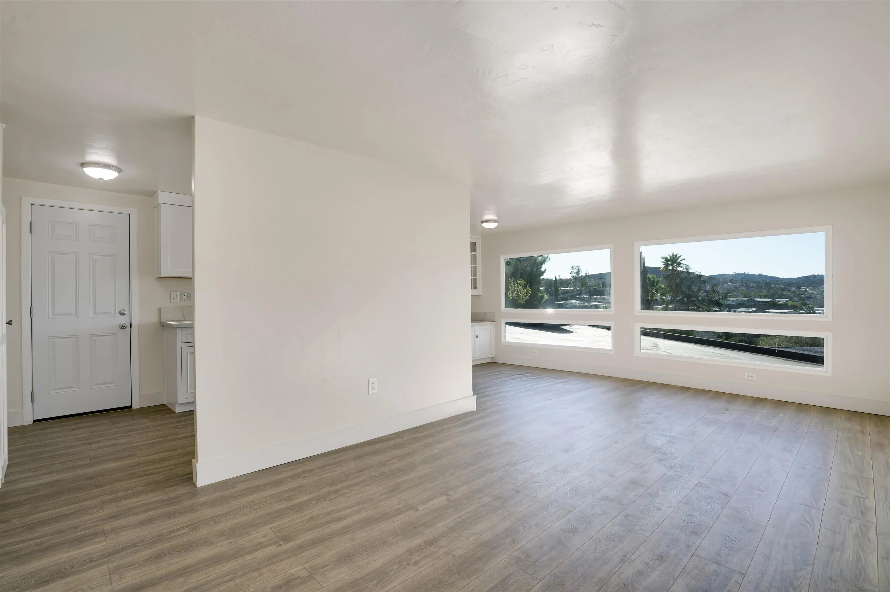 13490 Highway 8 Business, Unit SPC 14 Lakeside, CA 92040 - Photo 2 of 25 an empty room with wooden floor and windows