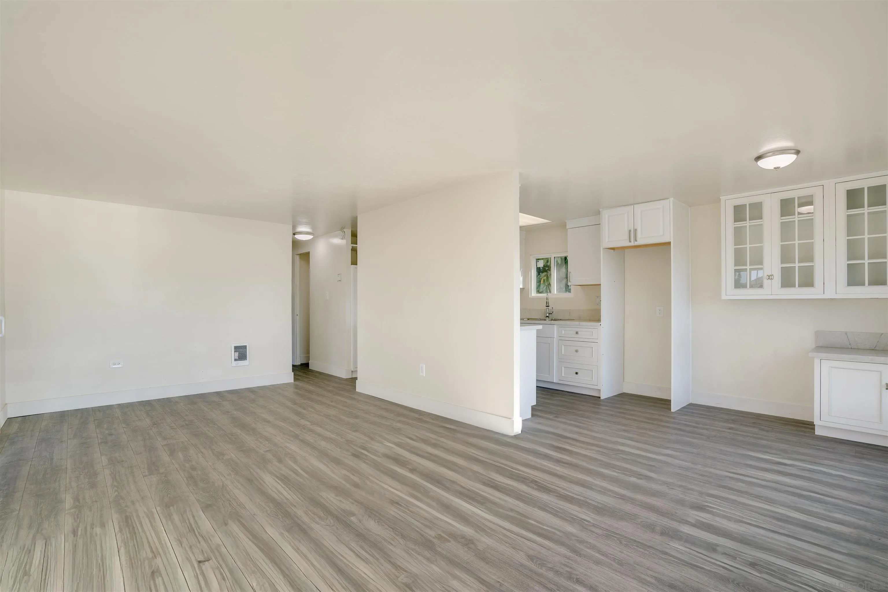 13490 Highway 8 Business, Unit SPC 14 Lakeside, CA 92040 - Photo 4 of 25 an empty room with wooden floor and windows