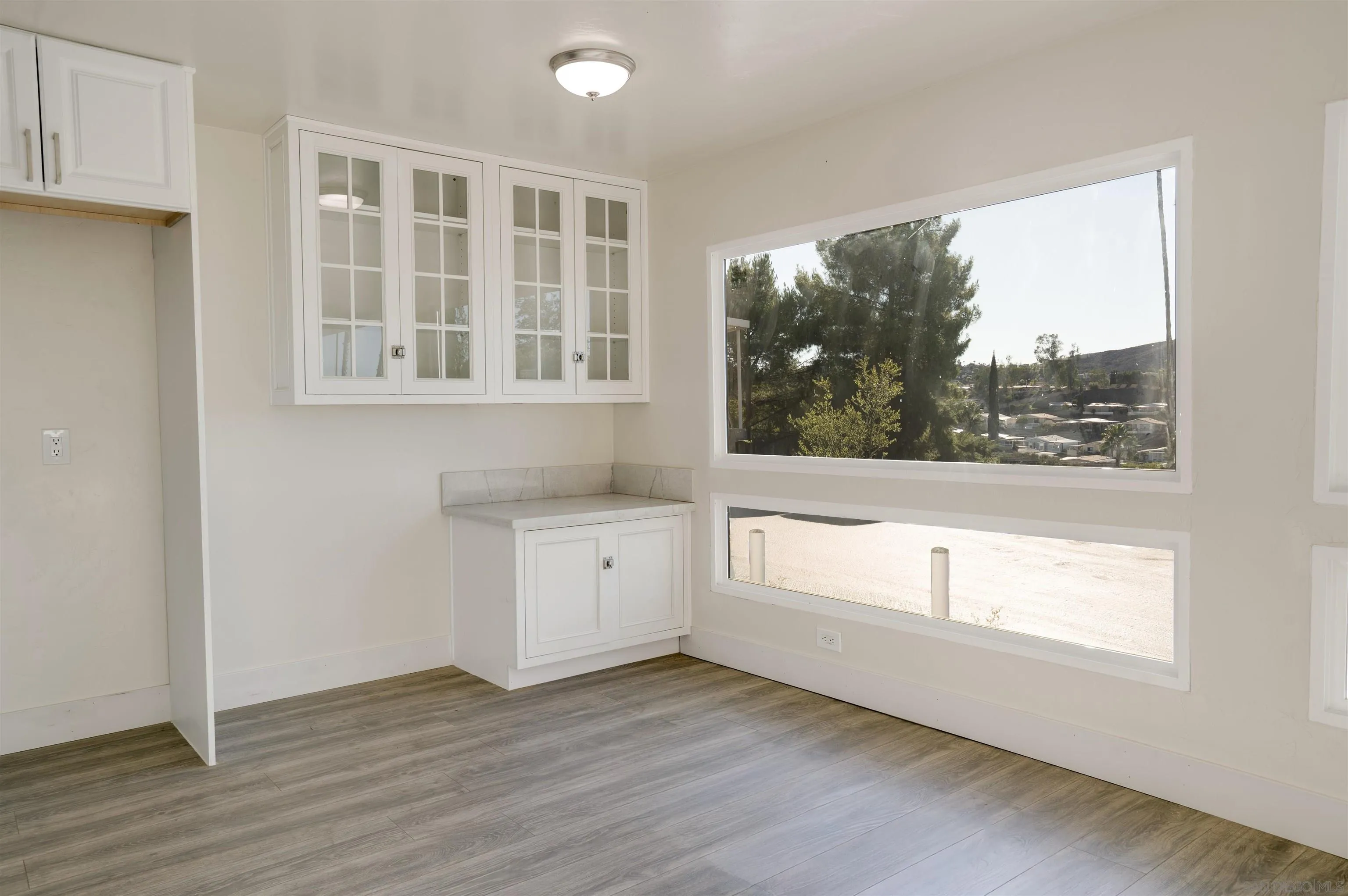 13490 Highway 8 Business, Unit SPC 14 Lakeside, CA 92040 - Photo 5 of 25 a view of an empty room with wooden floor and a window