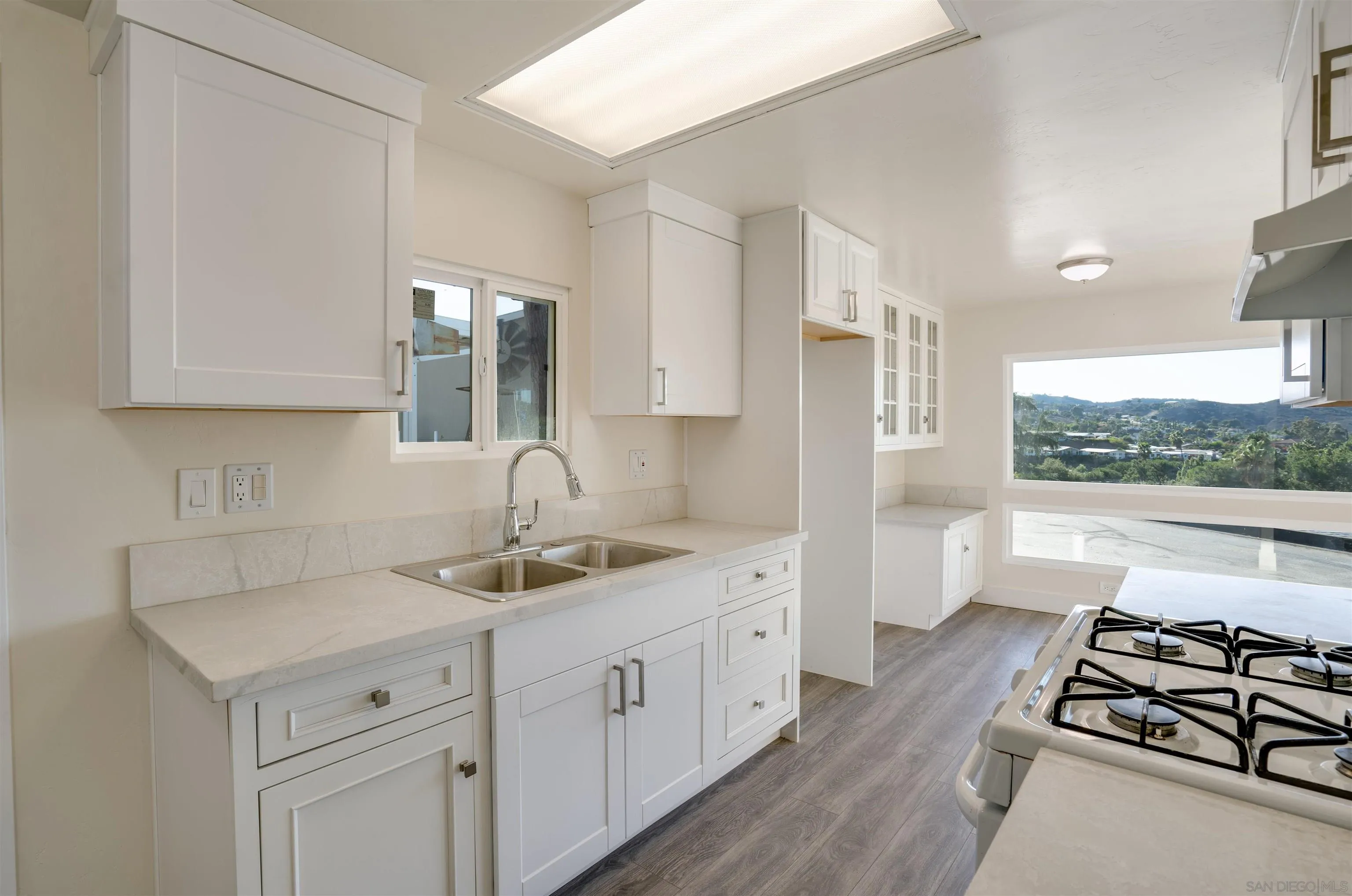13490 Highway 8 Business, Unit SPC 14 Lakeside, CA 92040 - Photo 9 of 25 a kitchen with stainless steel appliances a sink stove and cabinets