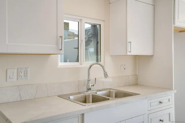 a kitchen with a sink and cabinets