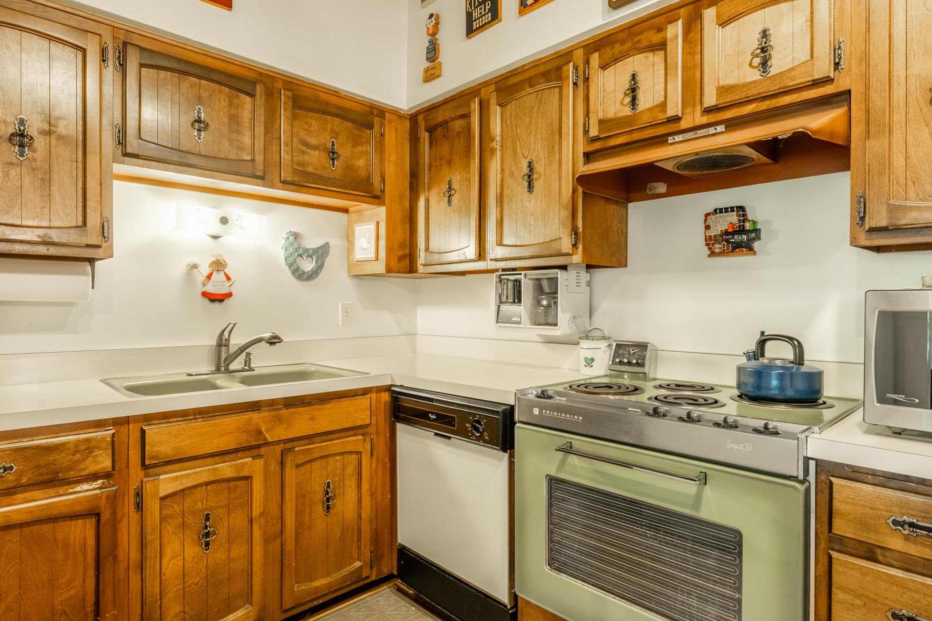 50 Hidden Valley Road, Unit 17 Mammoth Lakes, CA 93546 - Photo 14 of 40 Kitchen featuring wood cabinetry with decorative hardware, a double basin sink, white countertops, and a built-in dishwasher