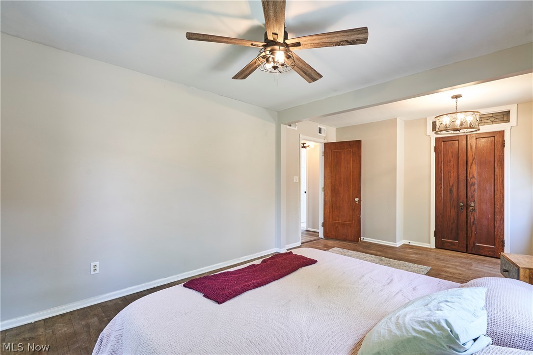780 Bates Road Rocky River, OH 44116 - Photo 19 of 35 Room featuring wood-finish flooring, a ceiling fan with light fixture, light-toned walls, a built-in closet with double wood doors, and an additional wood door