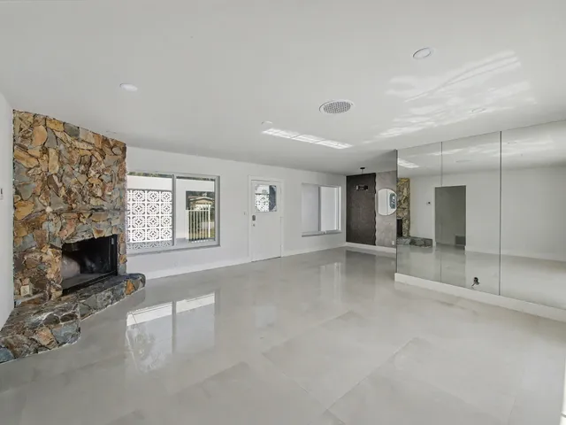 a view of an empty room with a fireplace