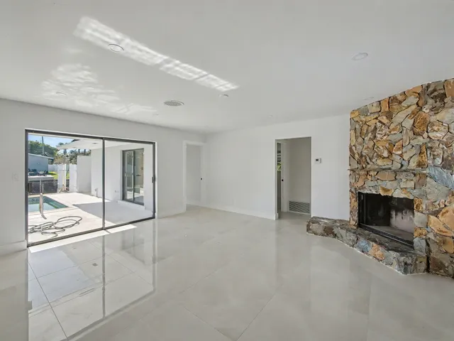 a view of an empty room with a fireplace