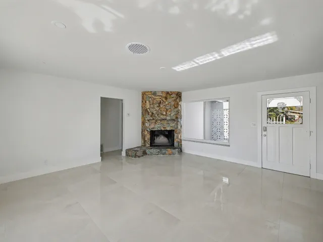 an empty room with furniture and a fireplace
