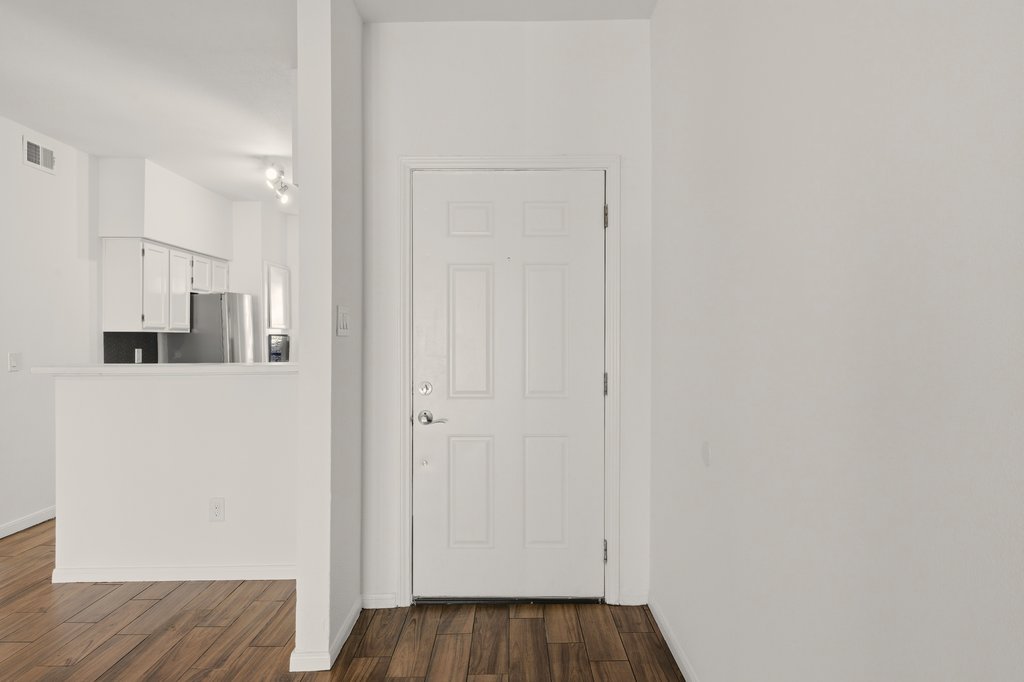 2450 Wickersham Lane, Unit 1006 Austin, TX 78741 - Photo 14 of 27 a view of a hallway with wooden floor and closet