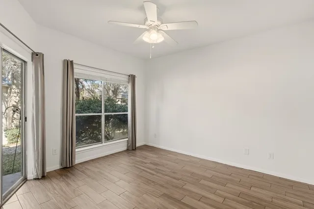 wooden floor in an empty room with a window