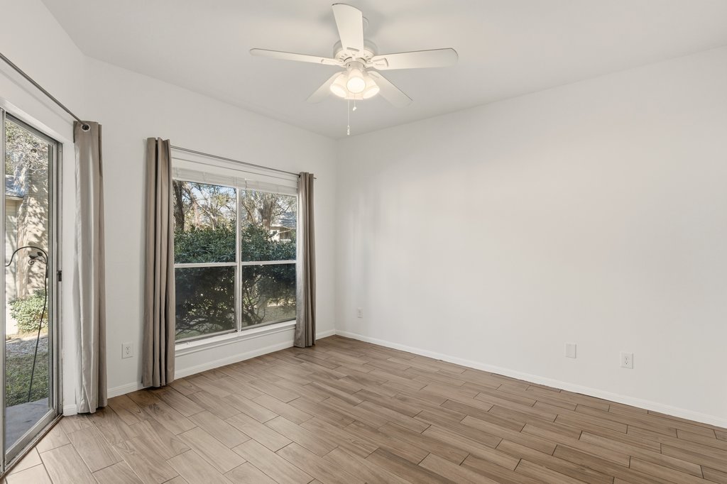 2450 Wickersham Lane, Unit 1006 Austin, TX 78741 - Photo 16 of 27 wooden floor in an empty room with a window