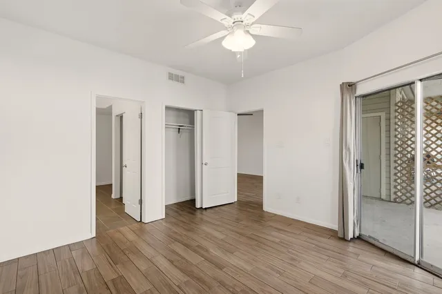 a view of a room with wooden floor and window