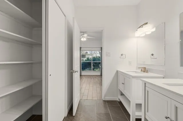 a bathroom with a double vanity sink and mirror