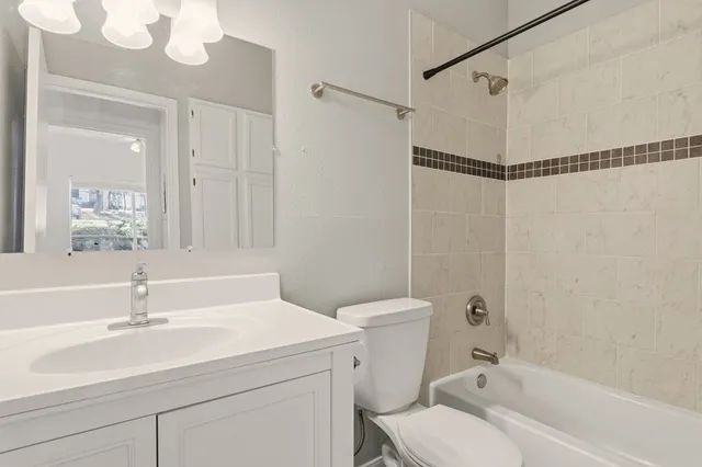 a bathroom with a sink toilet tub and shower