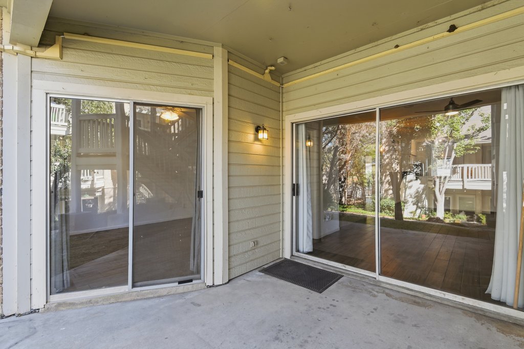 2450 Wickersham Lane, Unit 1006 Austin, TX 78741 - Photo 24 of 27 wooden floor and window in an empty room
