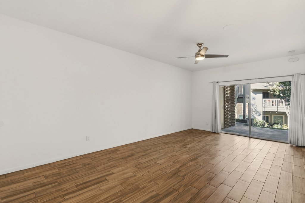 2450 Wickersham Lane, Unit 1006 Austin, TX 78741 - Photo 5 of 27 wooden floor in an empty room with a window