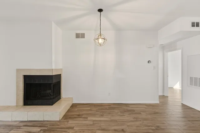 a room with a fireplace and wooden floor