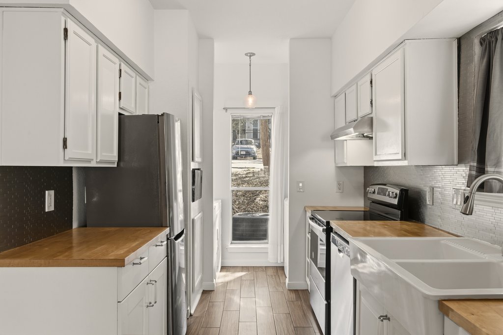 2450 Wickersham Lane, Unit 1006 Austin, TX 78741 - Photo 10 of 27 a kitchen with a sink a stove and refrigerator