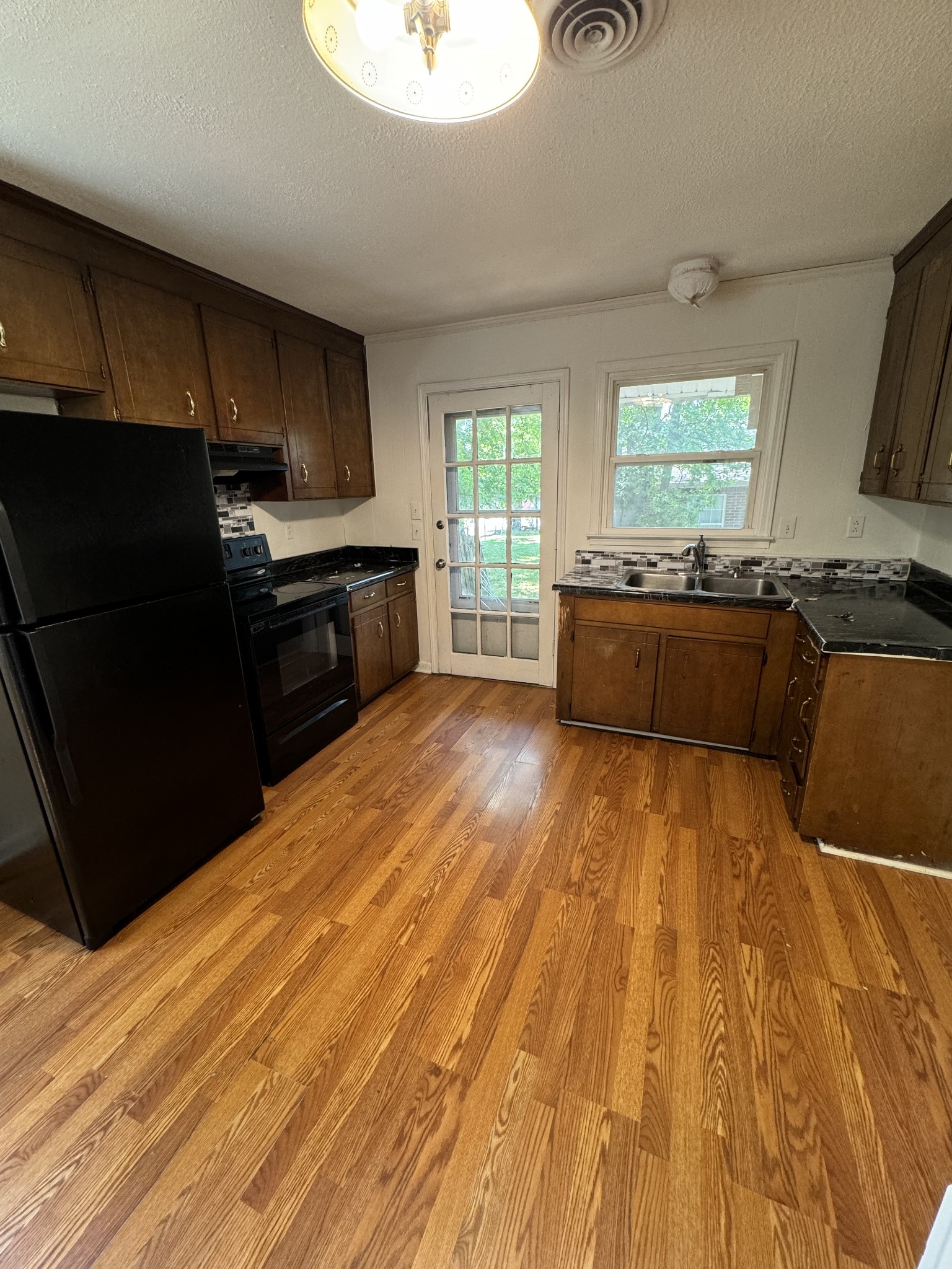 313 Bridge Avenue Murfreesboro, TN 37129 - Photo 3 of 6 a kitchen with granite countertop a refrigerator stove top oven and sink