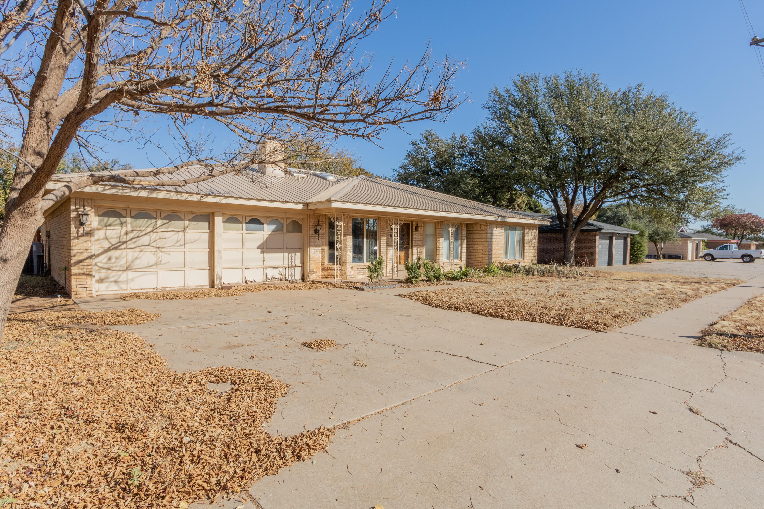 5714 73rd Street Lubbock, TX 79424 - Photo 1 of 38 a front view of a house with a yard