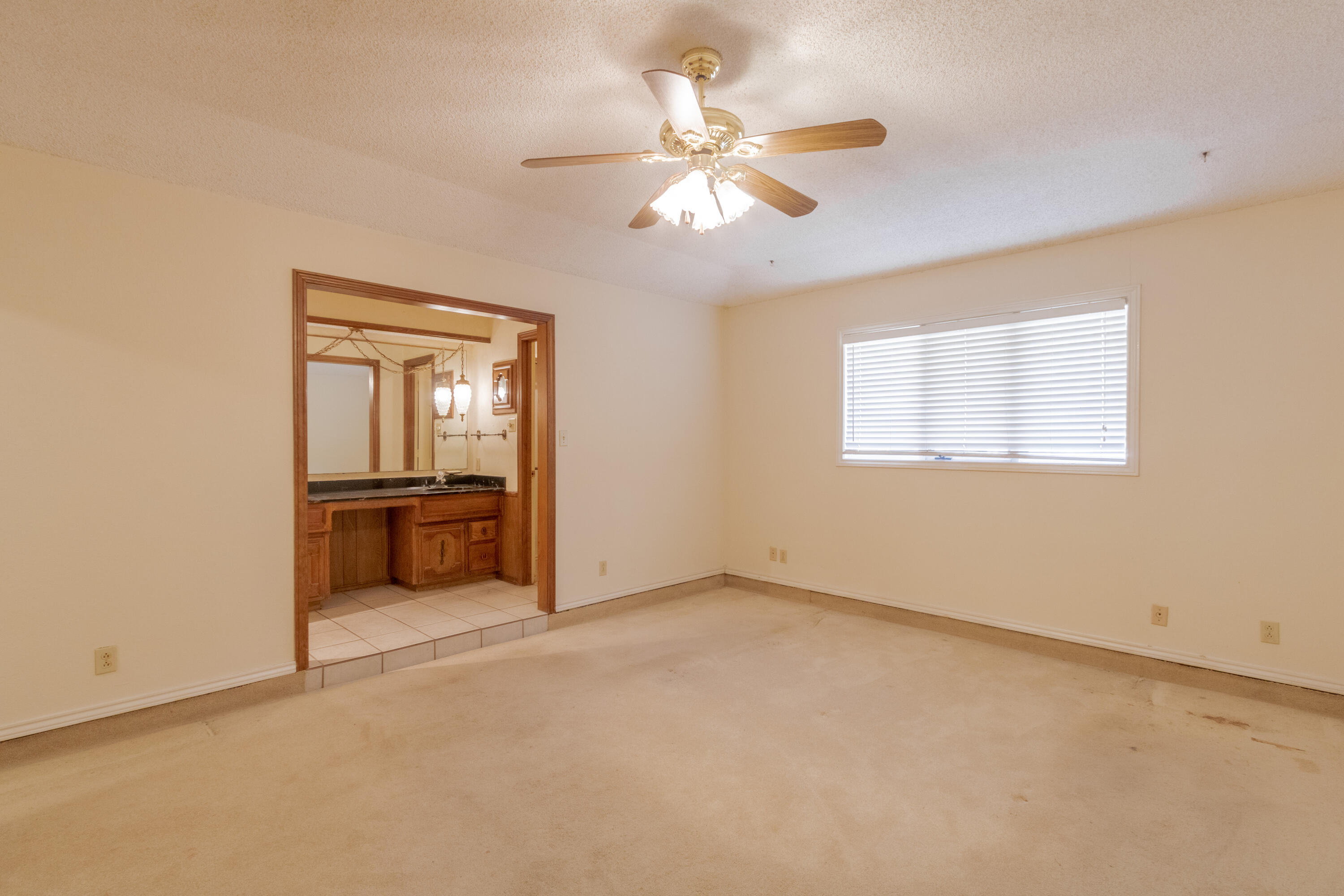 5714 73rd Street Lubbock, TX 79424 - Photo 15 of 38 an empty room with windows and ceiling fan
