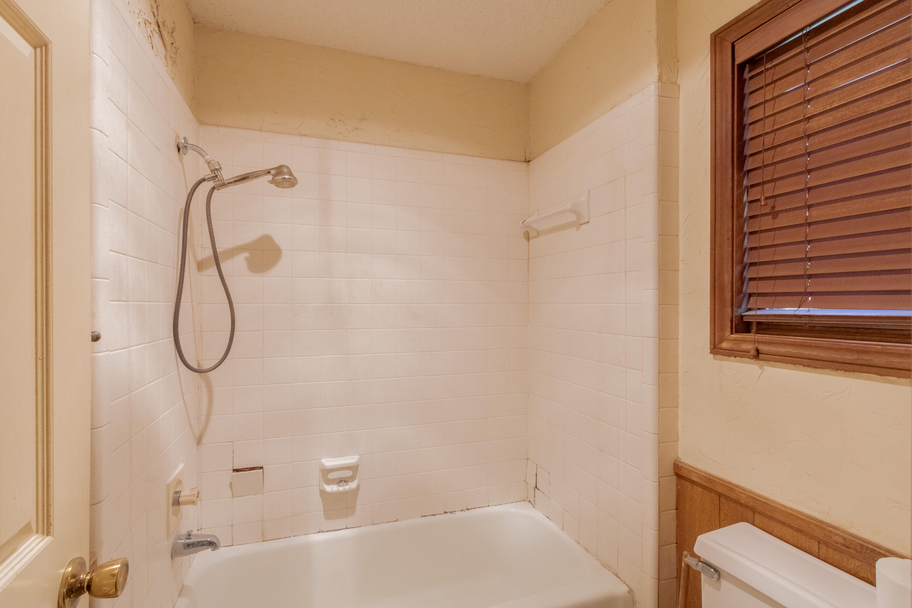 5714 73rd Street Lubbock, TX 79424 - Photo 19 of 38 a bathroom with a bath tub with a shower