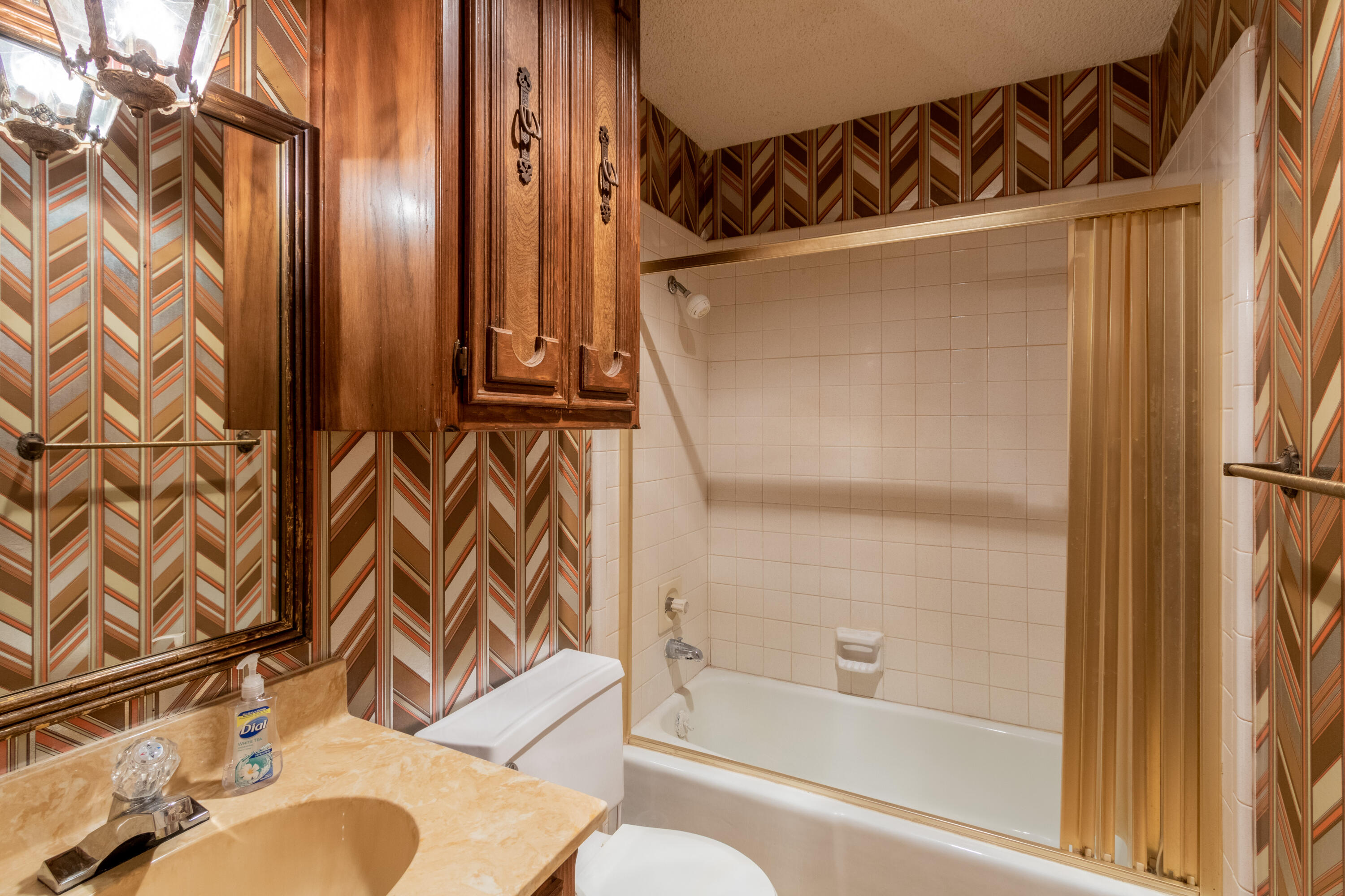 5714 73rd Street Lubbock, TX 79424 - Photo 24 of 38 a bathroom with a sink and a mirror