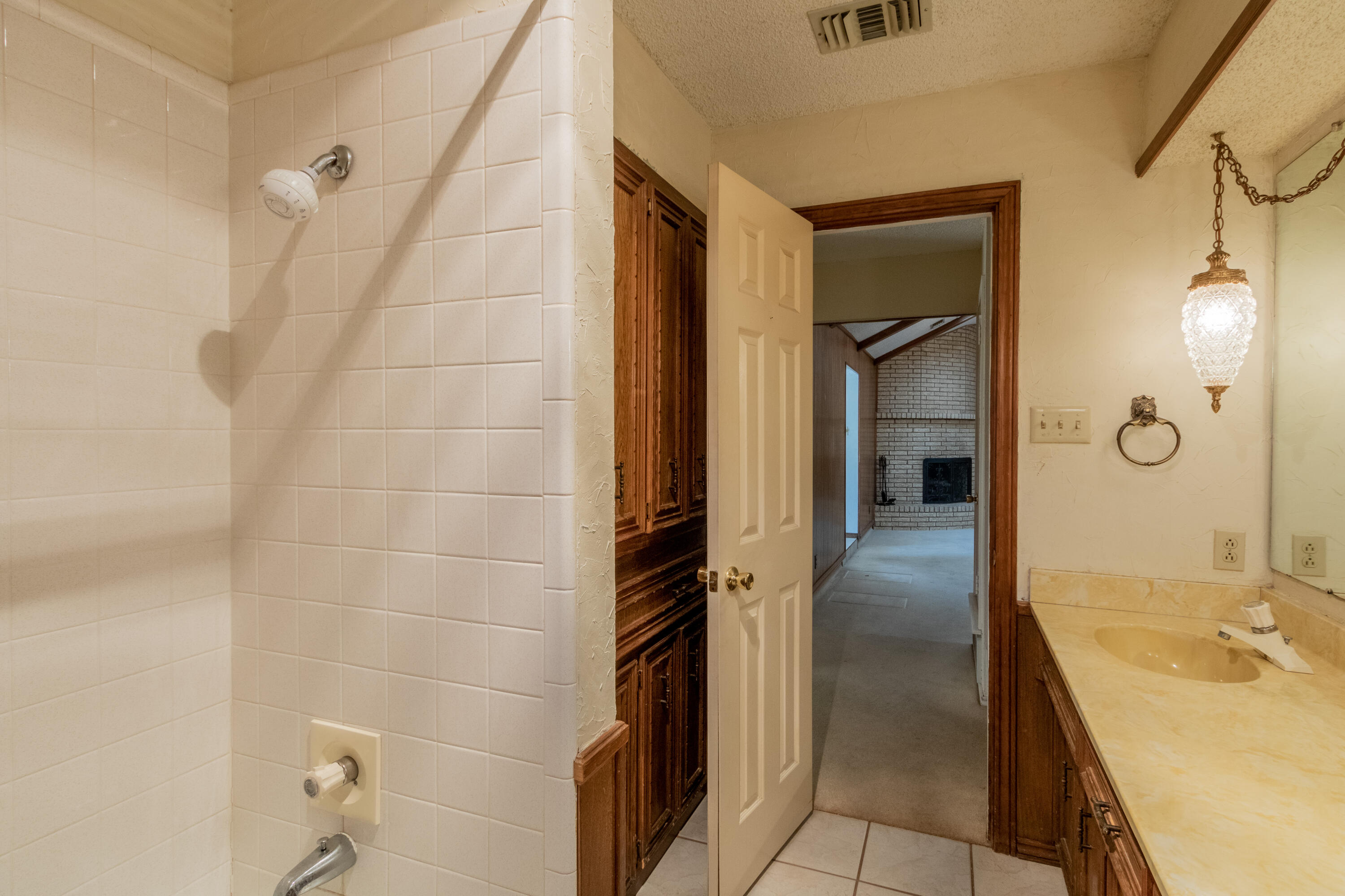 5714 73rd Street Lubbock, TX 79424 - Photo 30 of 38 a bathroom with a tub shower and sink