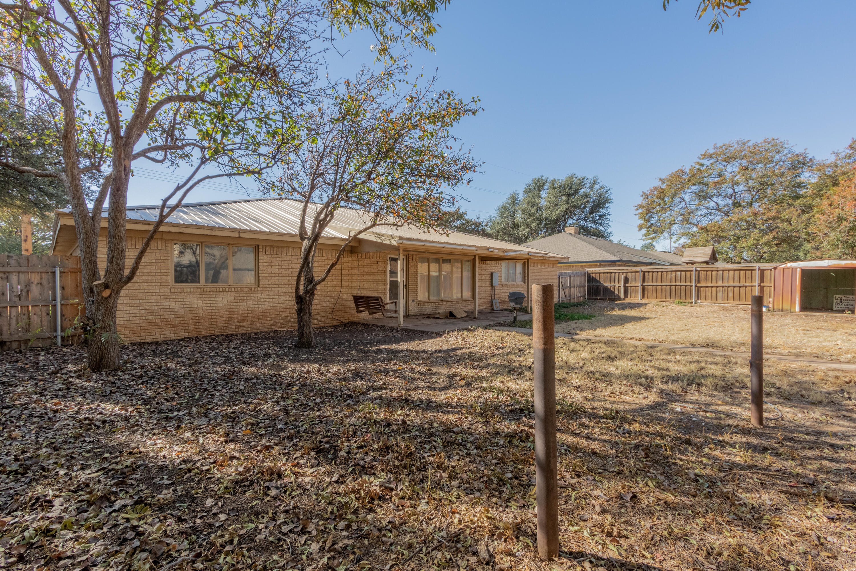 5714 73rd Street Lubbock, TX 79424 - Photo 33 of 38 a backyard of a house with lots of green space