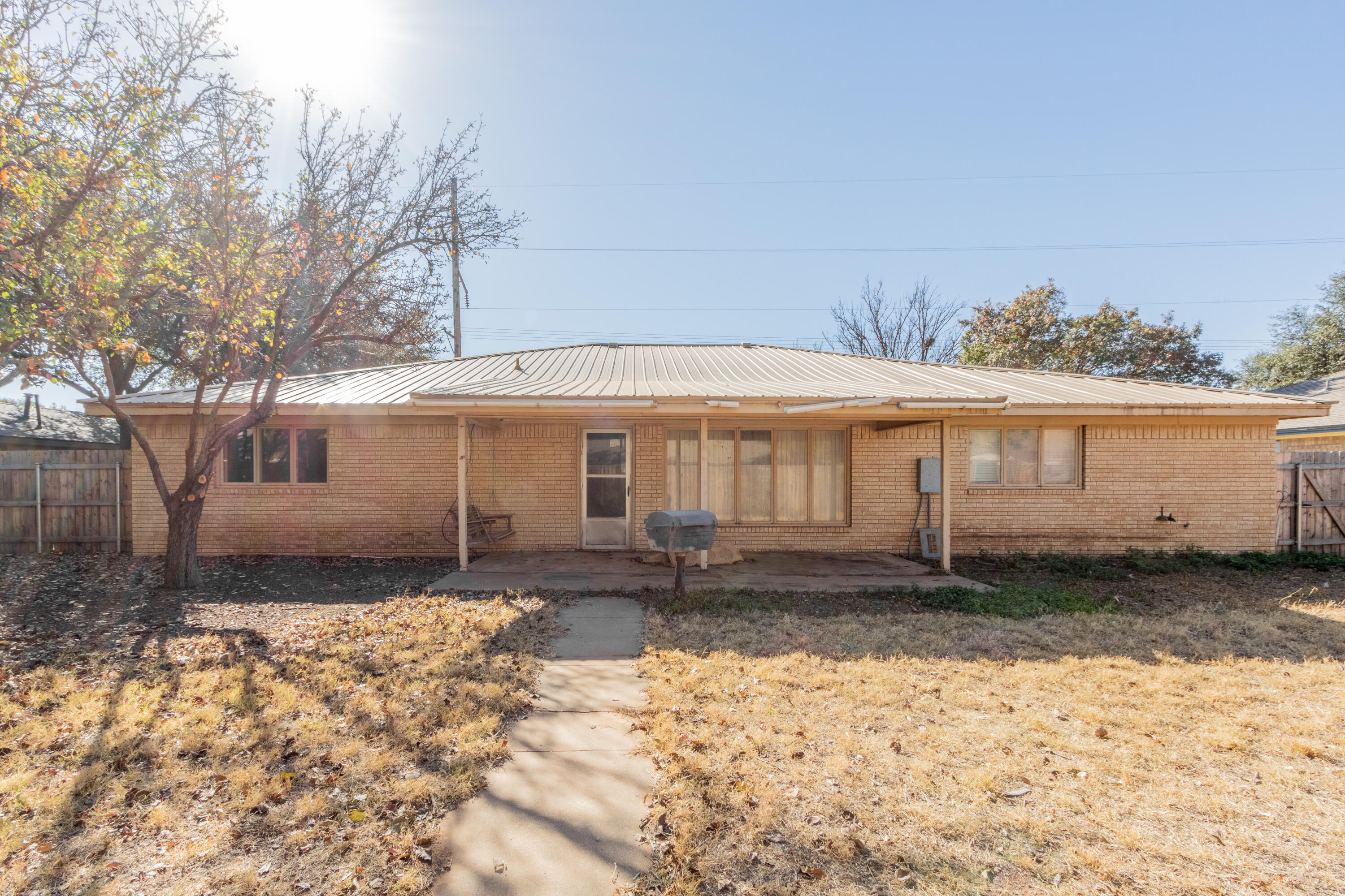 5714 73rd Street Lubbock, TX 79424 - Photo 34 of 38 a front view of a house with a yard