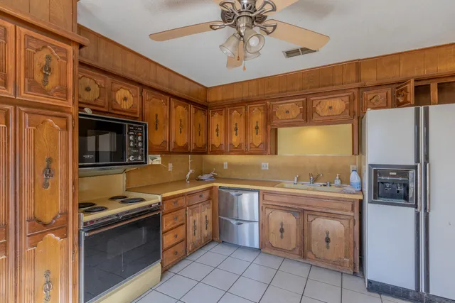 a kitchen with a sink cabinets and stainless steel appliances