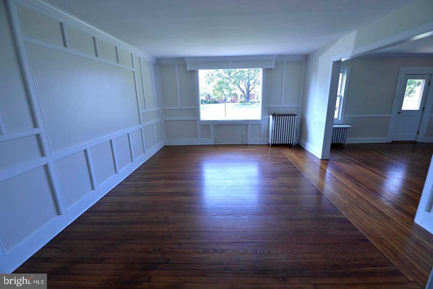 720 Church Hill Road Centreville, MD 21617 - Photo 7 of 16 a view of an empty room with wooden floor and a window