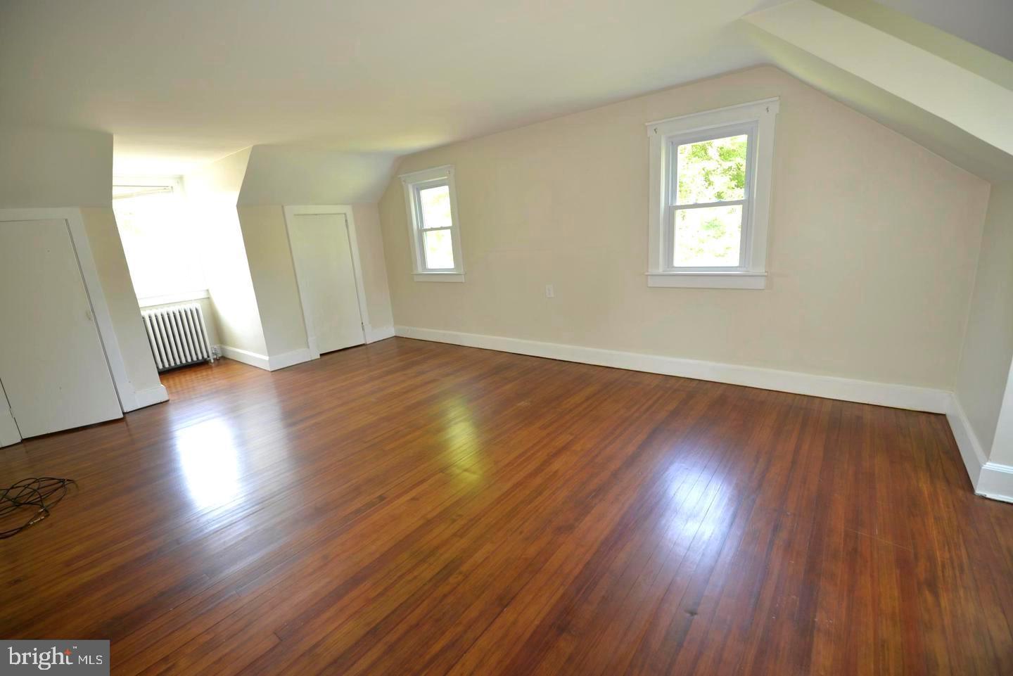720 Church Hill Road Centreville, MD 21617 - Photo 9 of 16 an empty room with wooden floor and windows