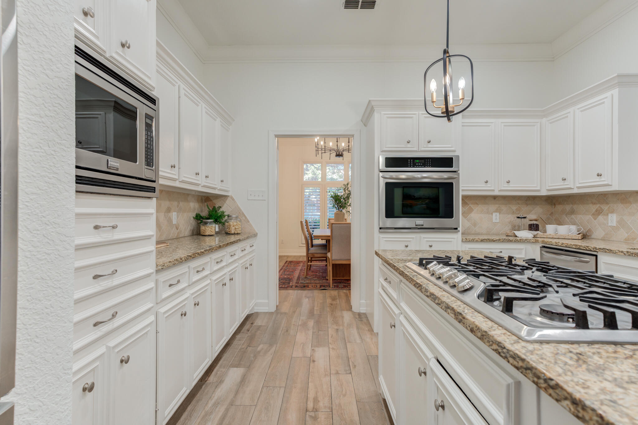 4707 85th Street Lubbock, TX 79424 - Photo 22 of 63 a kitchen with stainless steel appliances granite countertop a stove and cabinets