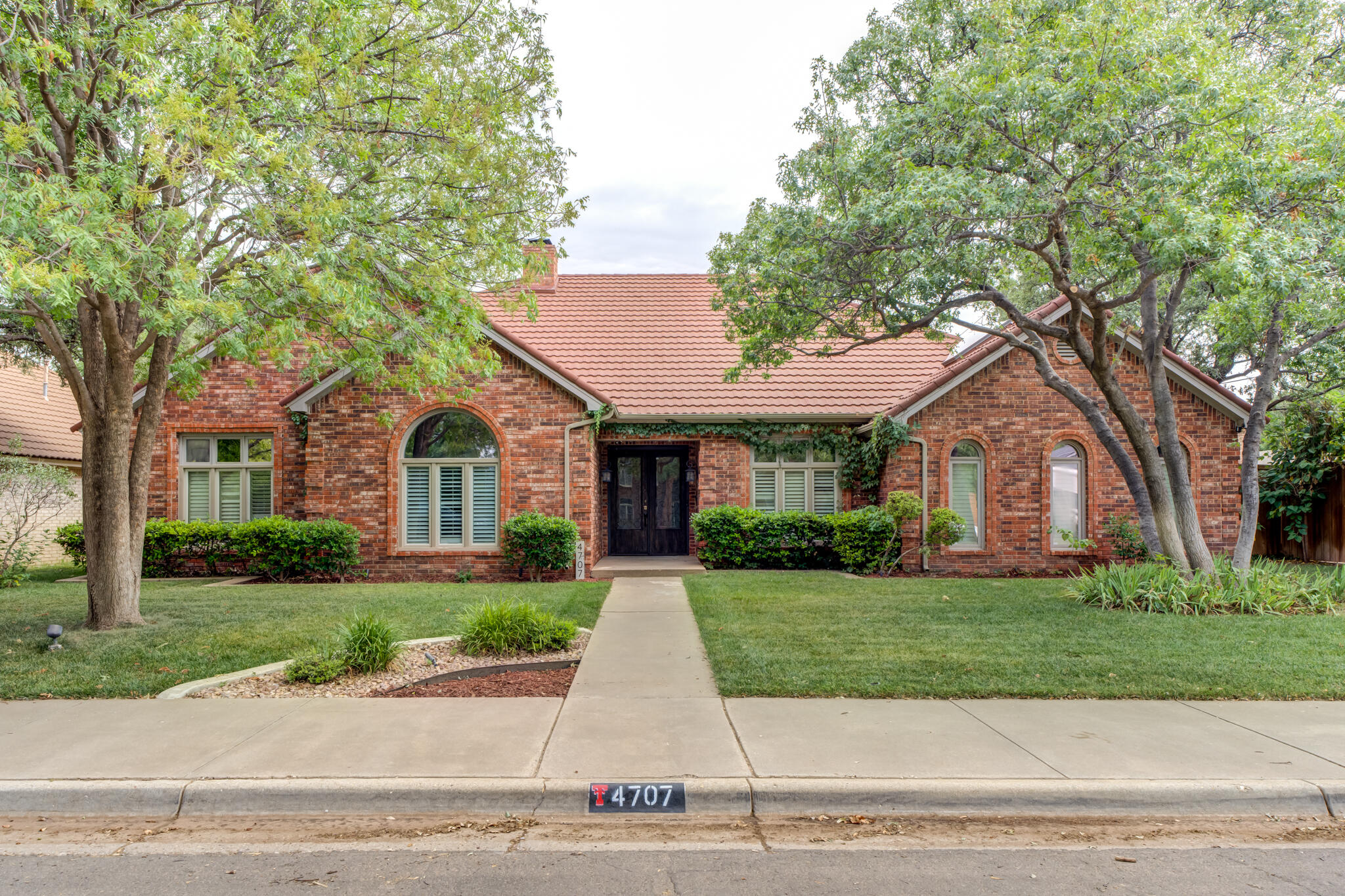 4707 85th Street Lubbock, TX 79424 - Photo 3 of 63 a front view of a house with a garden