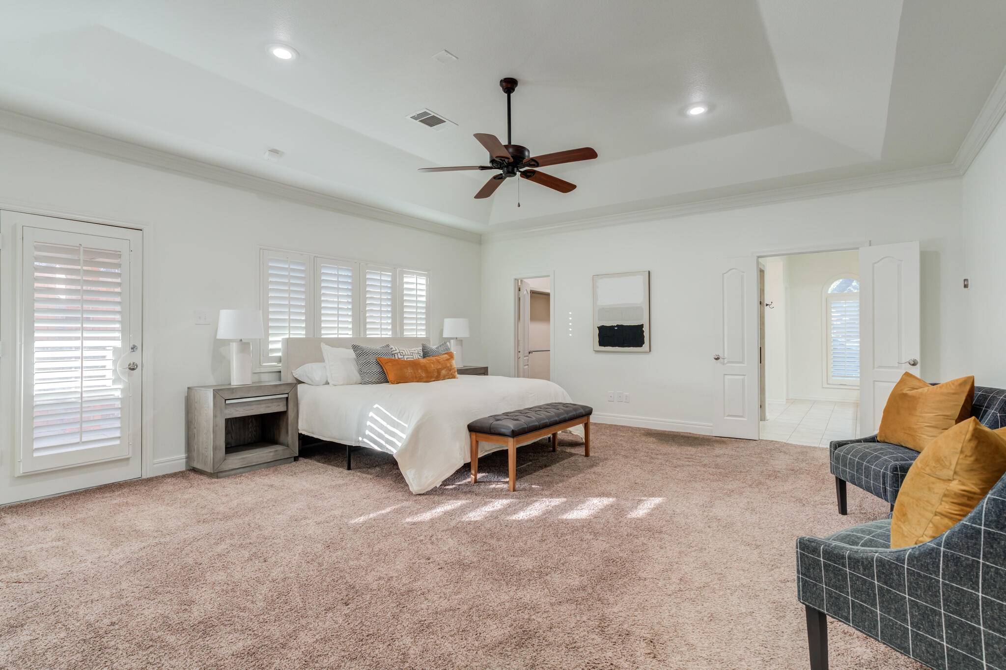 4707 85th Street Lubbock, TX 79424 - Photo 33 of 63 a spacious bedroom with a bed a couch and dresser