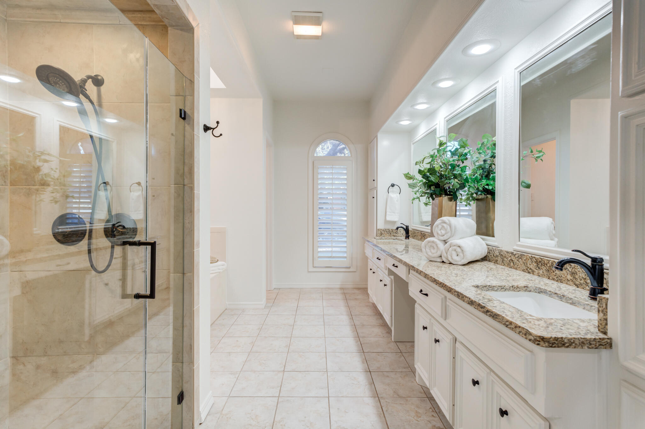 4707 85th Street Lubbock, TX 79424 - Photo 37 of 63 a spacious bathroom with a granite countertop sink a mirror and a shower