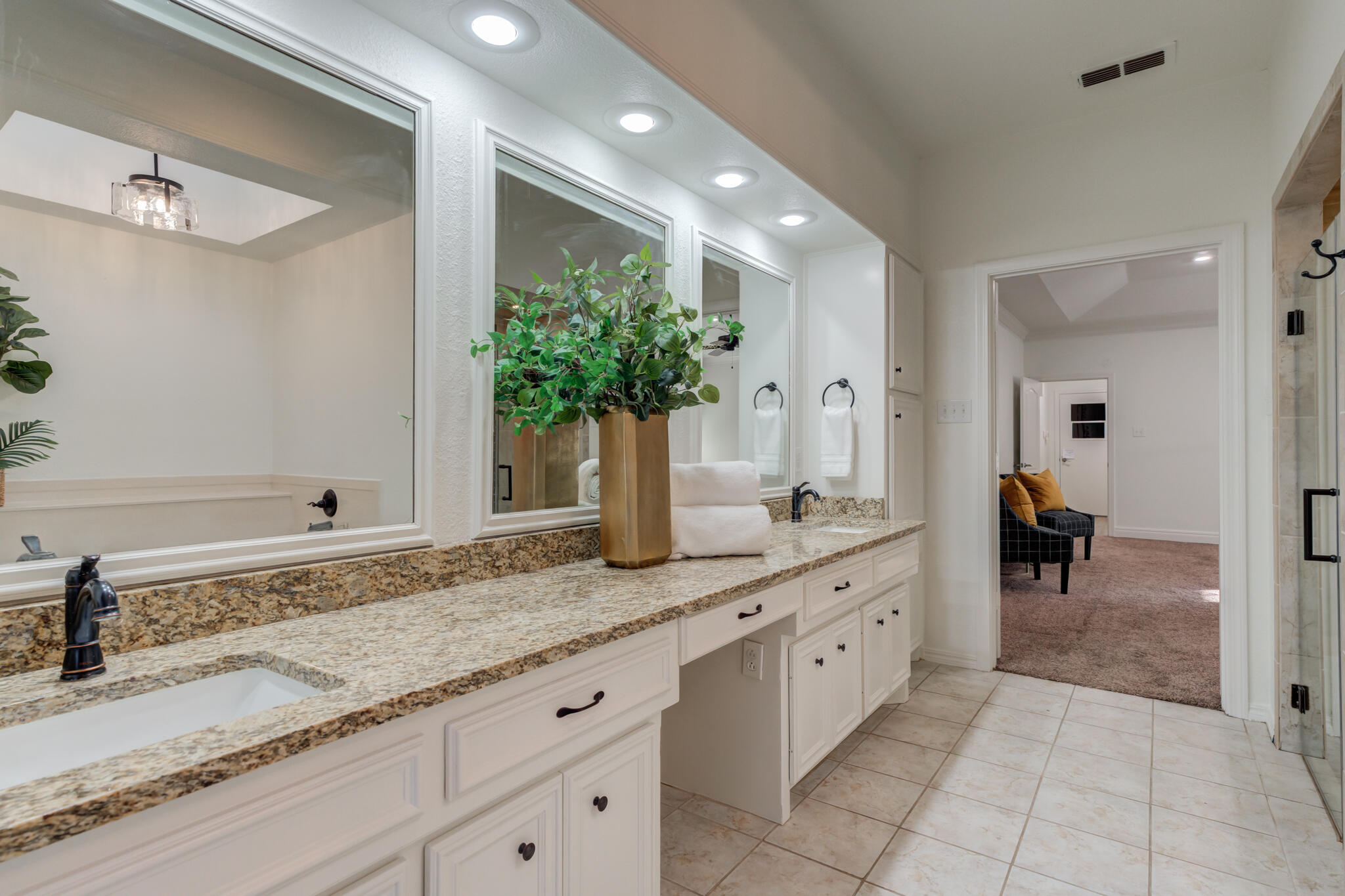 4707 85th Street Lubbock, TX 79424 - Photo 40 of 63 a spacious bathroom with a granite countertop sink and a mirror